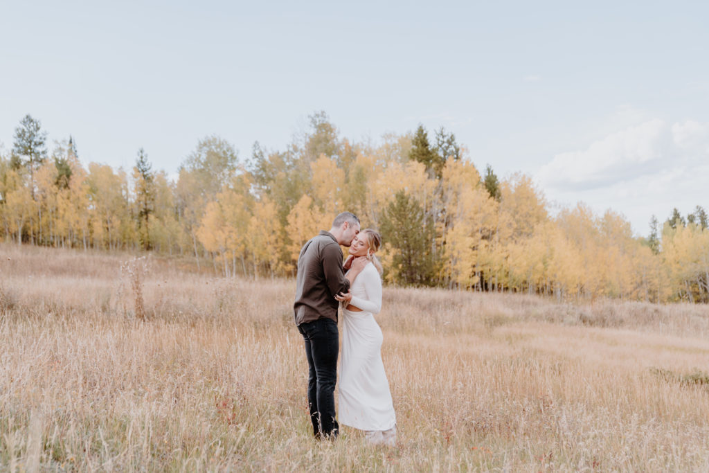 charming colorado engagement, couple standing together in field