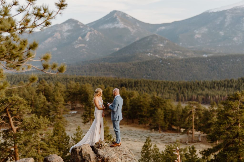 Couple eloping on a rock in Colorado with a stunning backdrop