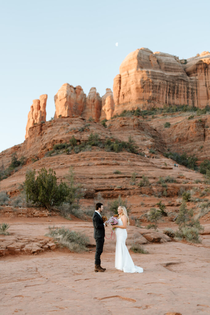 couple facing each other with Arizona red rocks in background