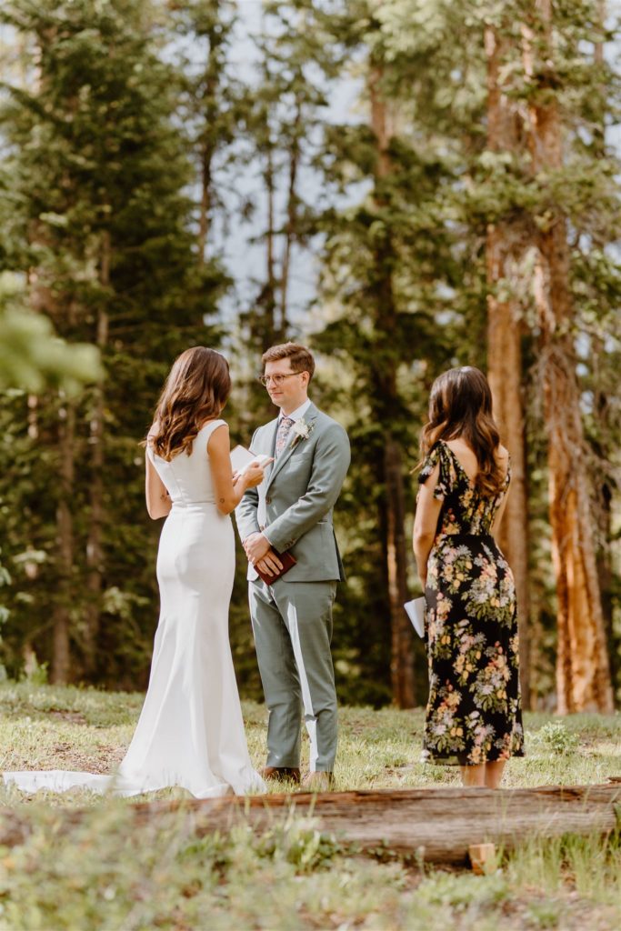 couple sharing their vows in the forest
