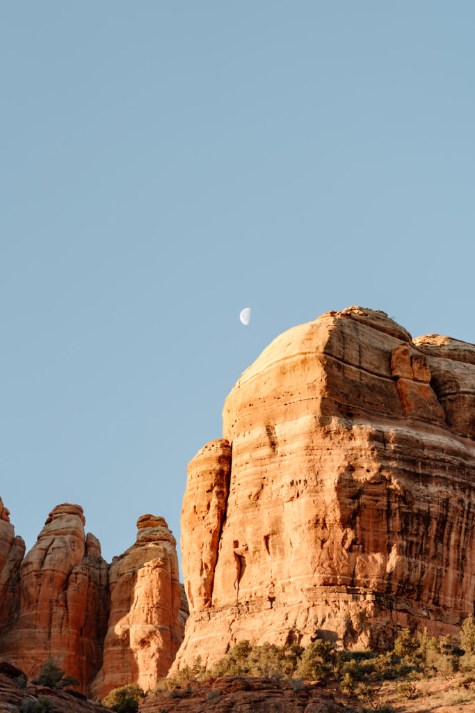 Arizona red rocks during the day with moon in sky