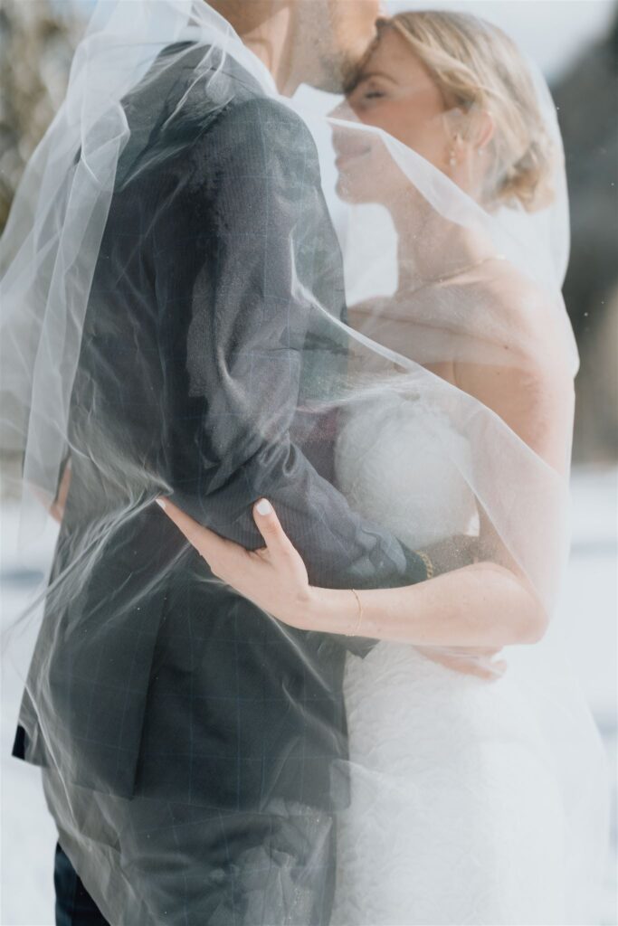 couple embracing under veil