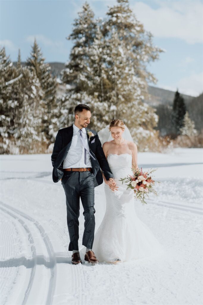 couple walking in snow holding hands