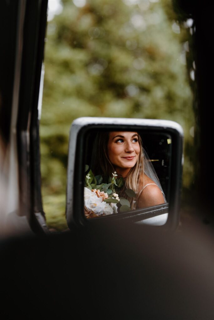 bride looking out window on jeep ride