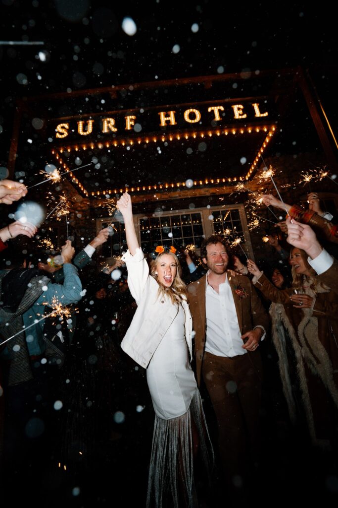 wedding couple sparkler exit while leaving the surf hotel