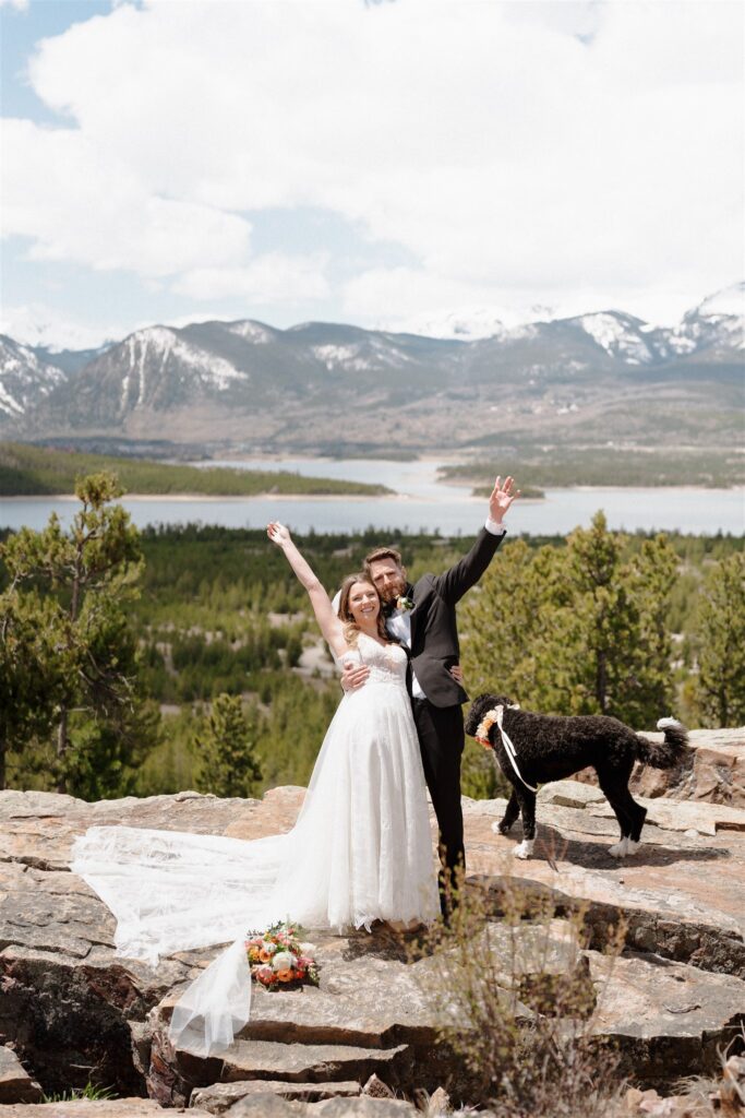 Couple on a mountain overlook celebrating their new marriage