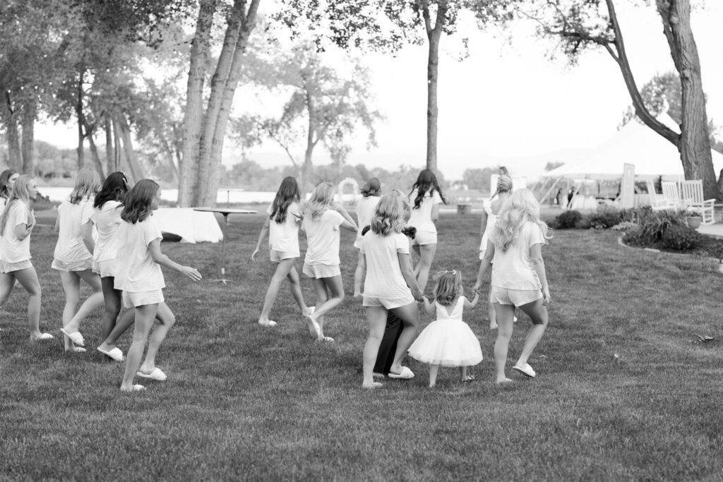 Little girls run around the ceremony lawn together