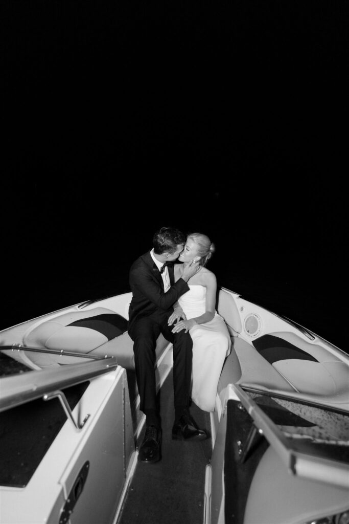 Bride and groom drive off onto the lake in their speed boat