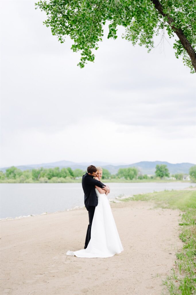 Bride and groom photos on the lake shoreline