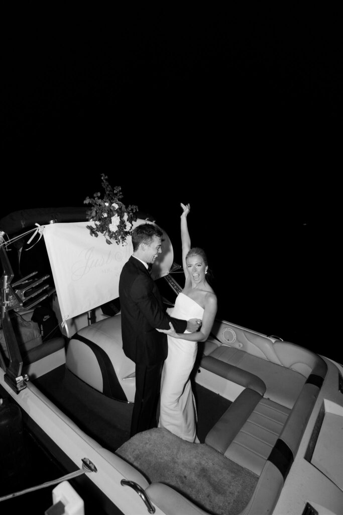 Bride and groom drive off onto the lake in their speed boat