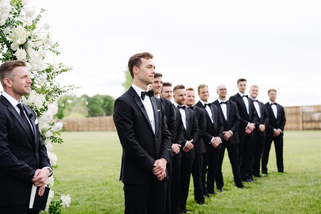 Groom watches his bride walk down the aisle