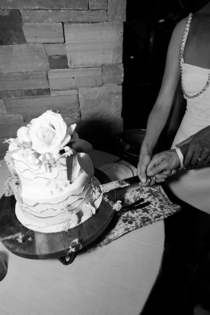 Bride and groom cutting their wedding cake