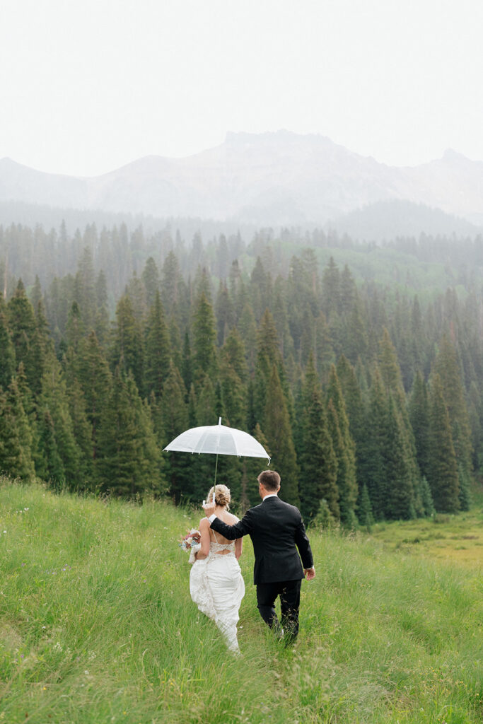 Bride and groom photos in the rain with a clear umbrella