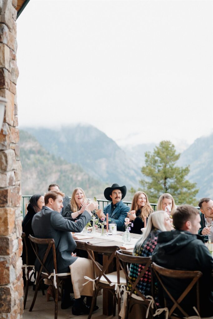 Wedding reception with friends and family gathered around the tables at Gold Mountain Ranch