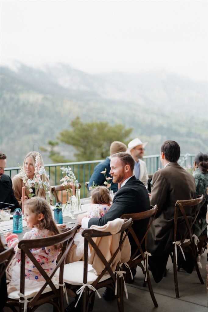 Wedding reception with friends and family gathered around the tables at Gold Mountain Ranch