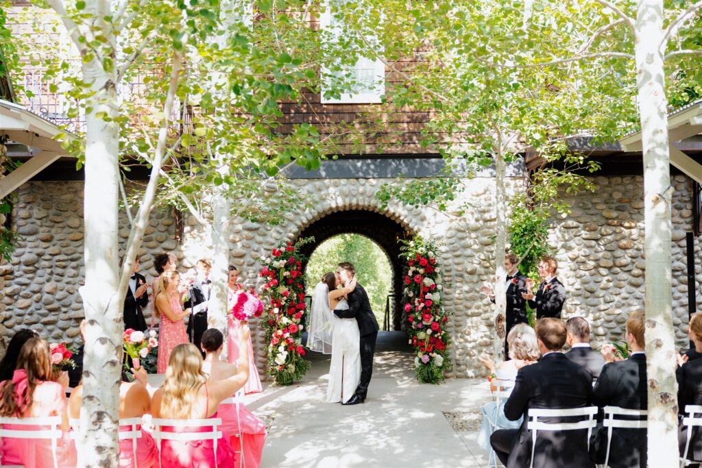 Bride and groom kiss at the altar