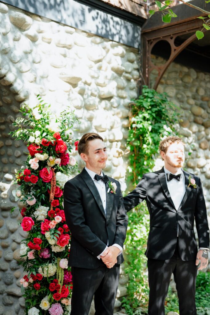 Groom watches his bride walk down the aisle in tears