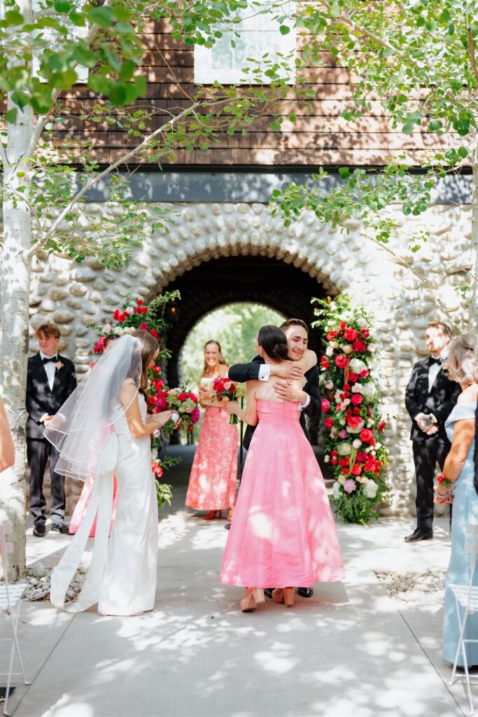 Bride's mother hands her off to the groom at the altar