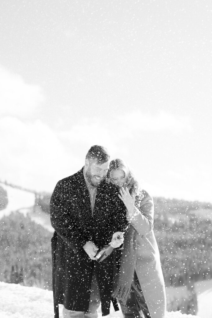 Couple celebrates after their successful winter proposal in Vail