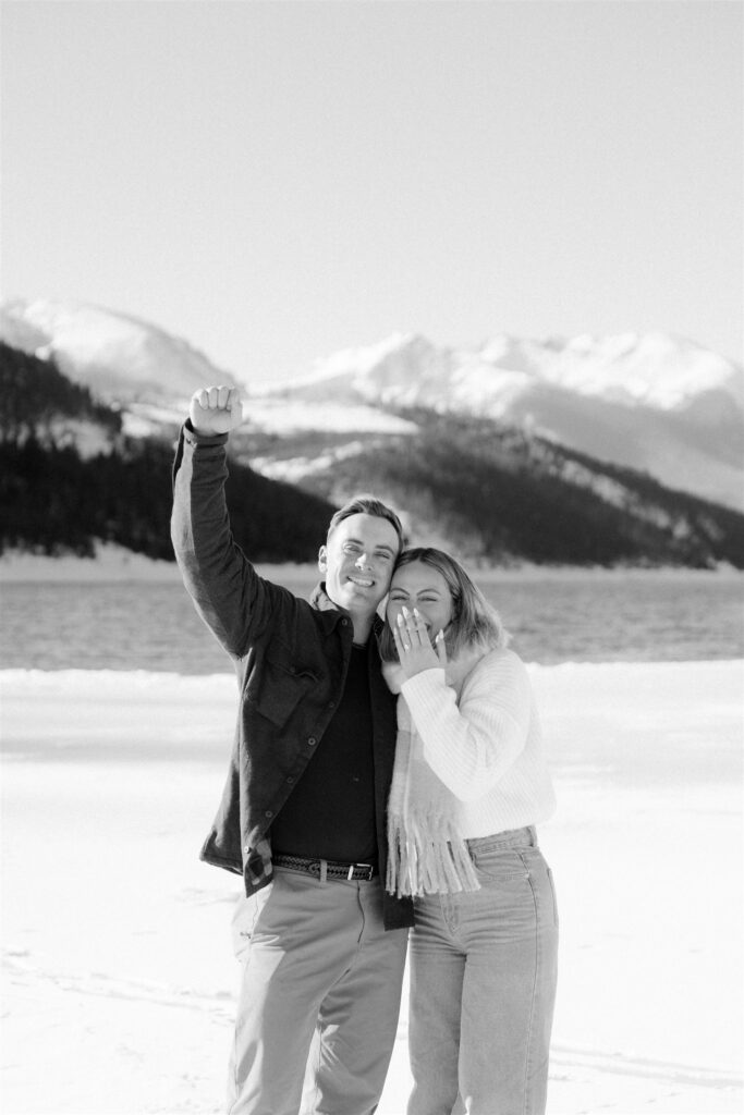 Couple celebrates after their successful winter proposal in Vail