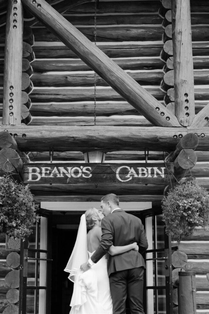 Bride and groom walk balk to Beano's Cabin after wedding portraits in the Colorado mountains