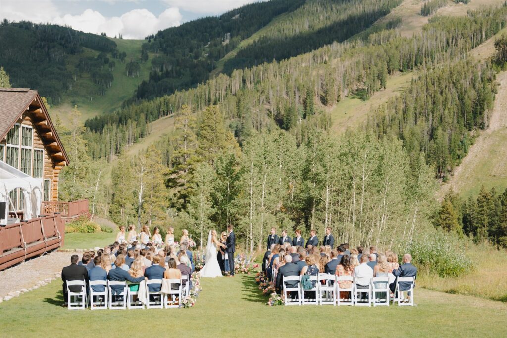 A Beano's Cabin wedding ceremony with a mountain backdrop