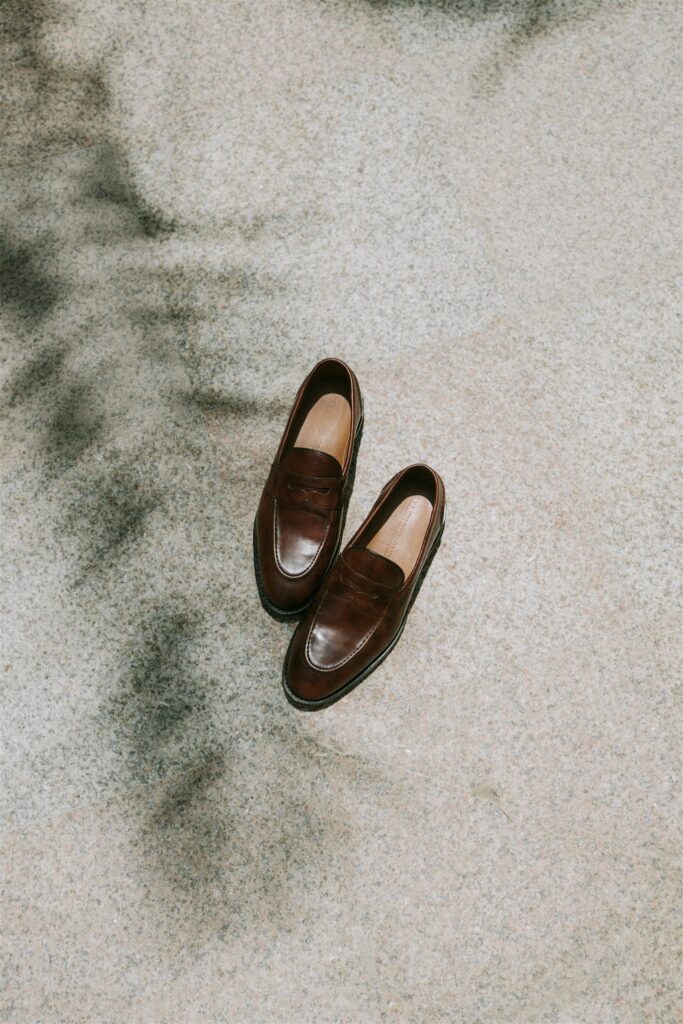 Groom's shoes in the white sand at Baja Luna