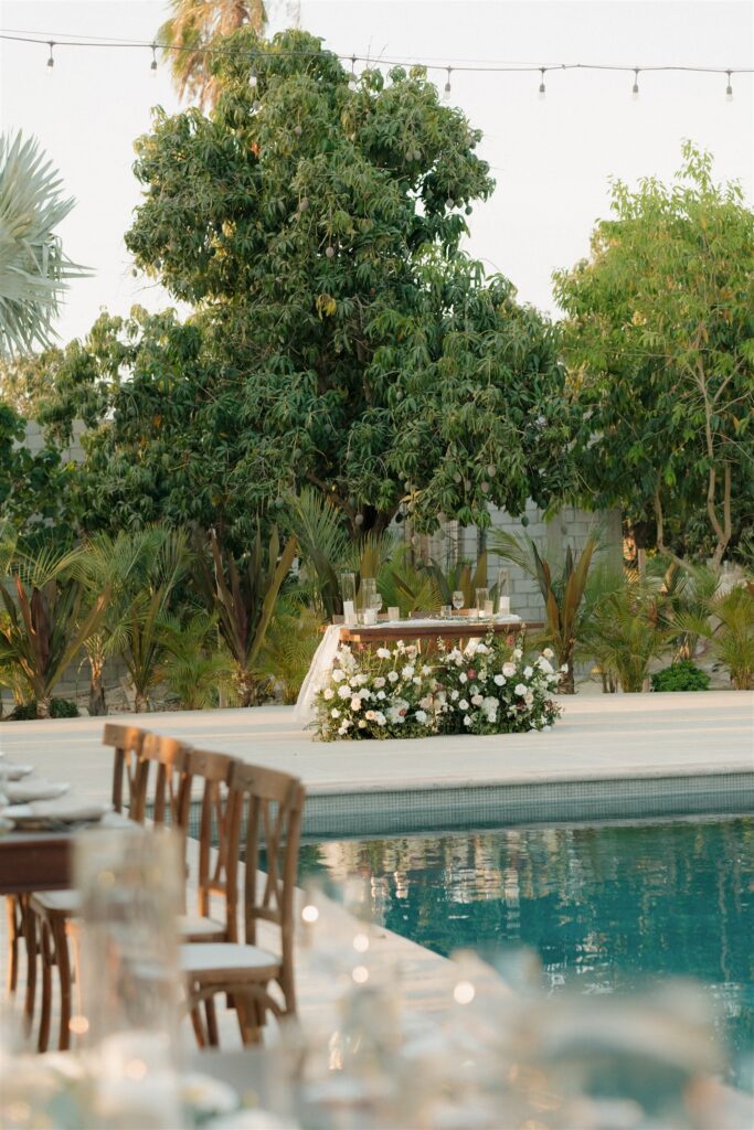 Bride and groom table sits by the pool at Baja Luna