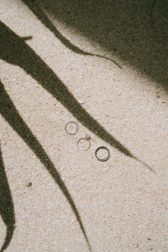 Wedding rings in the white sand at Baja Luna
