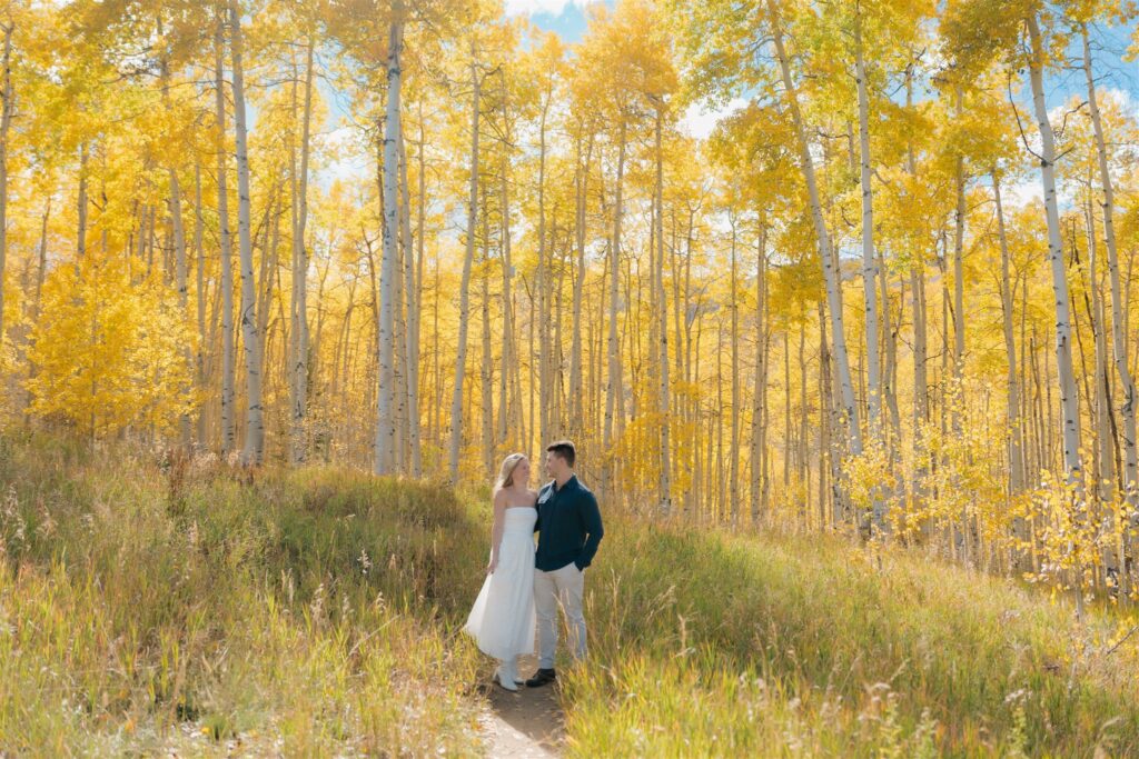 Colorado Fall Engagement Photos surrounded by golden aspen trees
