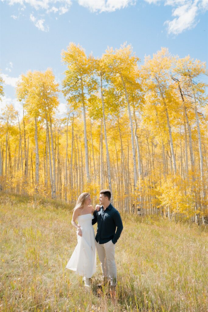 Colorado Fall Engagement Photos surrounded by golden aspen trees