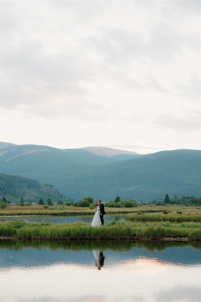 Alpine Lake bride and groom portraits in Colorado at sunset