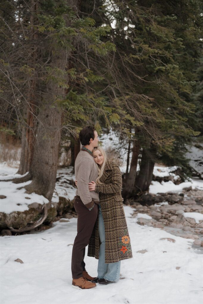 Snowy creekside engagement photos in Colorado