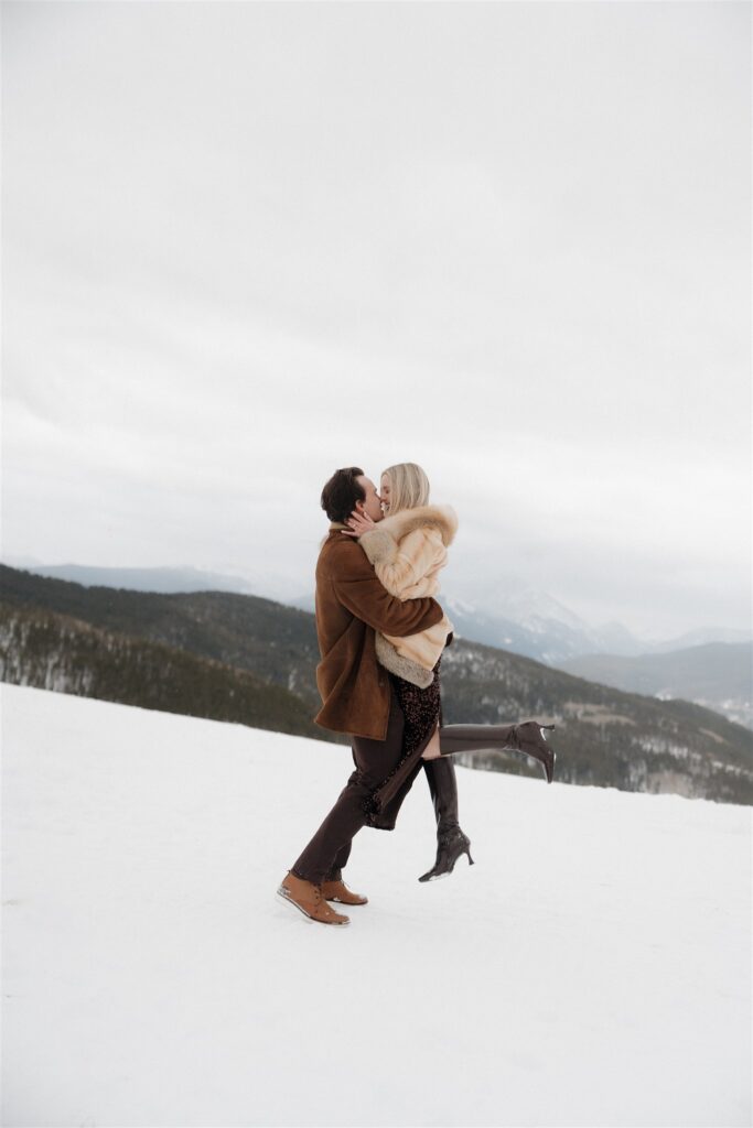 Playful winter engagement photos in the snow in Vail, Colorado