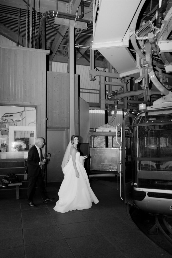 Father and bride jump on the Vail Mountain Gondola down to Holy Cross Event Deck