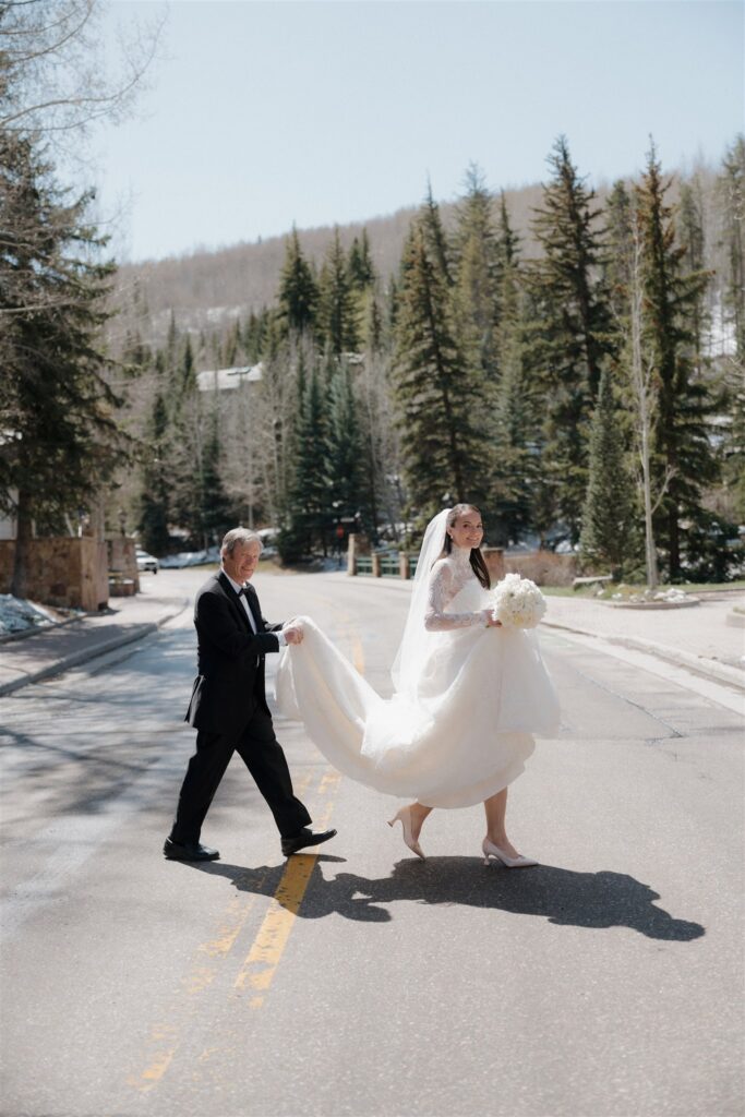 Bride and father walking to the Vail Chapel wedding ceremony