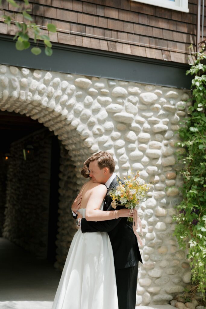 Bride and groom first look in front of a stone arch at the Surf Hotel in Buena Vista