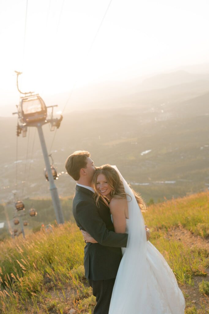 Mountaintop wedding portraits at sunset at Steamboat Resort with gondolas riding overhead