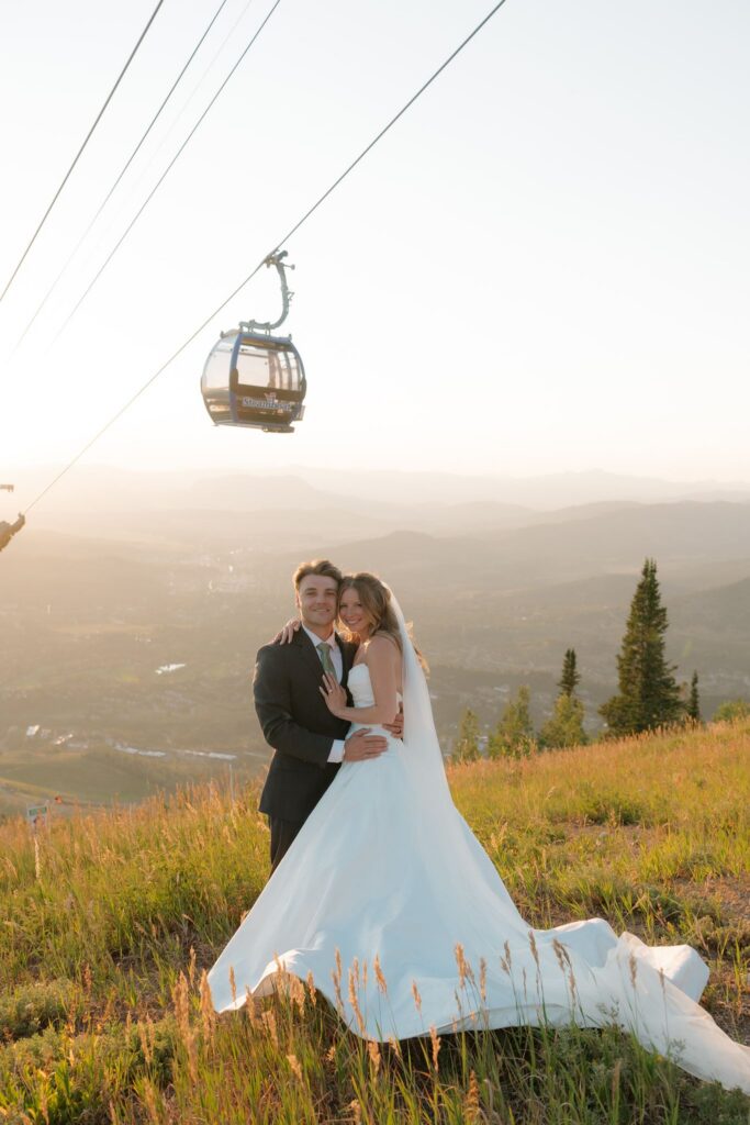 Mountaintop wedding portraits at sunset at Steamboat Resort with gondolas riding overhead